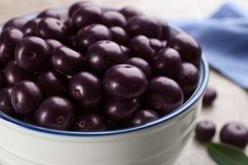 Fresh acai berries in bowl, closeup view