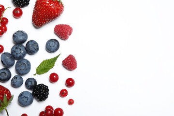 Mix of fresh berries on white background, flat lay. Space for text