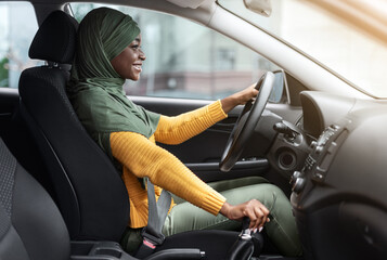 New Transport. Happy Black Islamic Lady In Hijab Driving Modern Car
