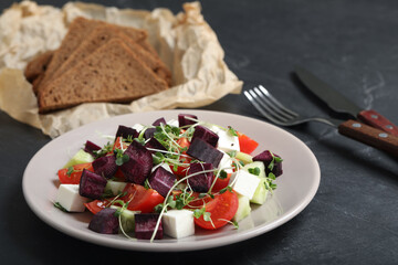 Delicious carrot salad served on black table, closeup