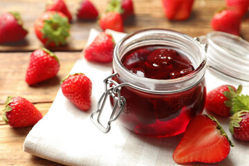 Delicious pickled strawberry jam and fresh berries on wooden table