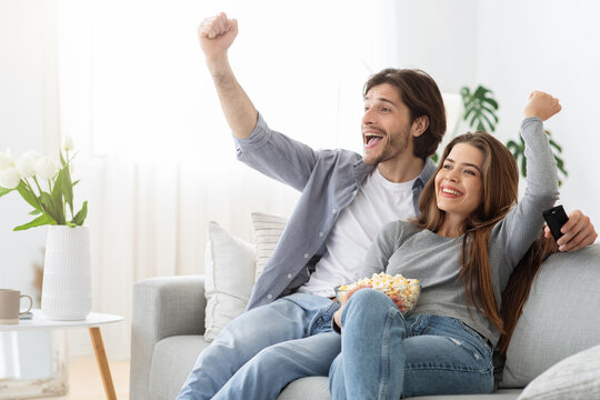 Happy Young Couple Football Fans Watching Game On TV