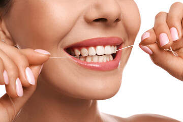 Young woman flossing her teeth on white background, closeup. Cosmetic dentistry