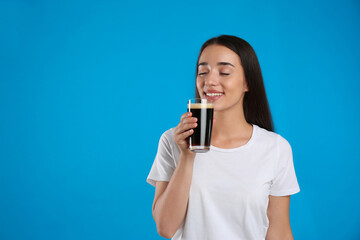 Beautiful woman with cold kvass on blue background. Traditional Russian summer drink