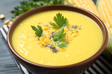 Delicious creamy corn soup on table, closeup