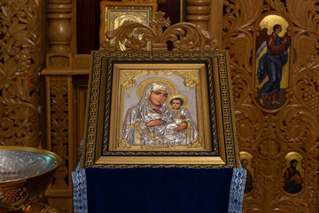 Fototapeta na wymiar An orthodox icon on a church pulpit. When worshipers enter the church they will kiss this icon and cross themselves.