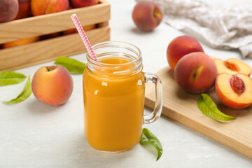 Natural freshly made peach juice on white table