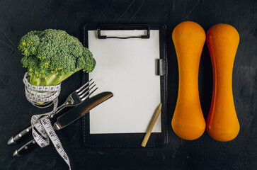 Concept of healthy dieting with broccoli on black stone background