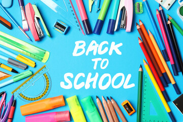 Text Back To School and different stationery on blue background, flat lay