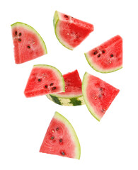 Fresh watermelon pieces falling on white background