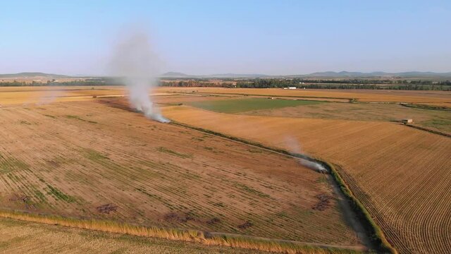 Aerial images with camera movement around the smoke columns of an agricultural fire