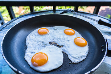Fried eggs in a pan in outdoor
