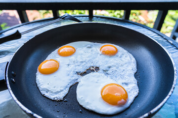 Fried eggs in a pan in outdoor