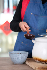 The Chinese in the traditional festival Laba Festival prepare to scoop the boiled Laba congee into a bowl