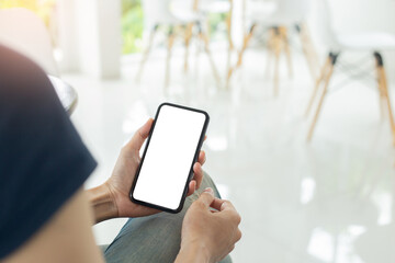 cell phone mockup blank white screen.woman hand holding texting using mobile on desk at coffee shop.background empty space for advertise.work people contact marketing business,technology