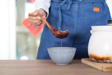 Chinese chef put Laba porridge in casserole into a bowl