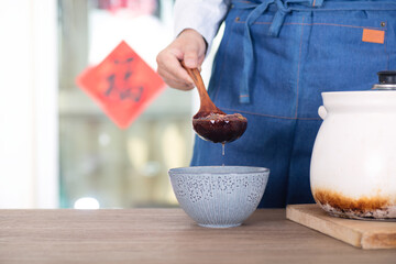 Chinese chef put Laba porridge in casserole into a bowl