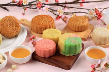 Concept Various Mooncake, Traditional and Colorful Snow Skin Moon Cake, Dessert for Mid-Autumn Festival on Pink Background, Close up, Lifestyle.