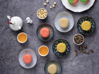 Colorful Snow Skin Moon Cake, Sweet Snowy Mooncake, Traditional Savory Dessert for Mid-Autumn Festival on Stone Background, Selected Focus