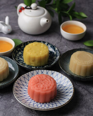 Colorful Snow Skin Moon Cake, Sweet Snowy Mooncake, Traditional Savory Dessert for Mid-Autumn Festival on Stone Background, Close up, Lifestyle. Selected Focus
