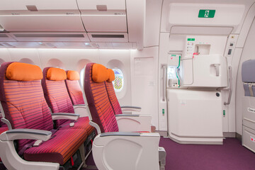 Airplane interior, seats, window and Emergency exit on an aircraft, view from inside of the plane.
