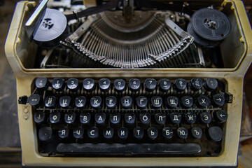 Black keyboard of a vintage typewriter with the Cyrillic alphabet. Close-up of rusty soviet typewriter with Russian letters.