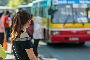 Young girl waiting for bus at bus station. Closeup.