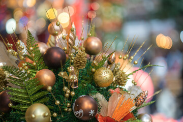 Christmas decorative basket with pine leaves, pine fruit, balls, golden flowers....