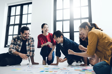 Cheerful male and female new gen business people celebrating winning success project, emotional multiracial members excited with success in productive working process on startup