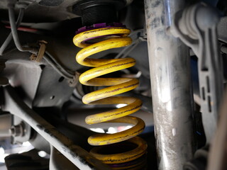 maintaining a car shock absorbers at garage.