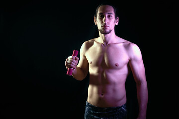 Fit young male training alone despite coronavirus pandemic at home in a dark background