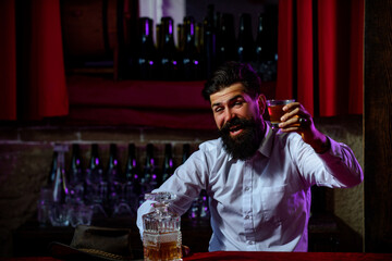 People drinks alcohol concept, happy man drinking expensive beverage at bar or pub.