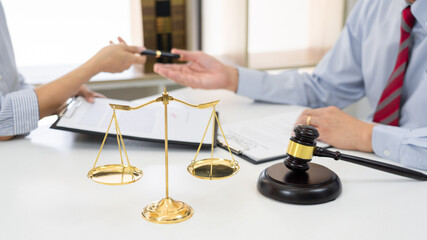 Client with his partner lawyers or attorneys discussing discussing a document or contract agreement working at table in office, Good service cooperation.