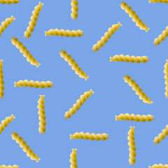 Obraz premium Fusilli pasta random flat lay on blue background without shadow. can be used as raw pasta background, poster, banner not pattern.