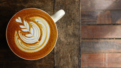 a cup of latte art coffee on wooden background                           