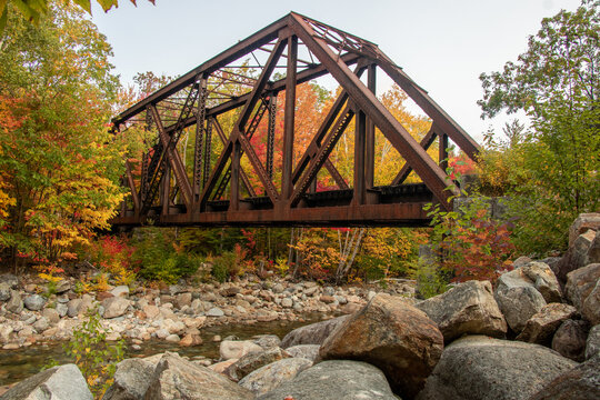 Railway steel bridge on a river during autumn season