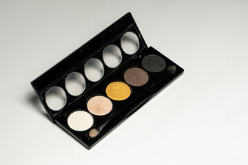 Close-up of eyeshadow palettes with brushes isolated on white background. Beauty industry and make-up products.