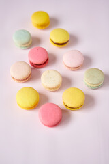French cake macaron. Set of cute sweets on pastel pink background. almond cookies, pastel colors, top view