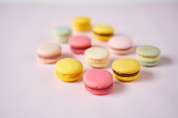 French cake macaron. Set of cute sweets on pastel pink background. almond cookies, pastel colors, top view