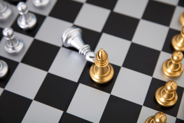 Chess pieces in a duel on a chess board