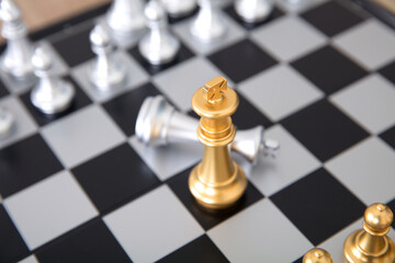 Chess pieces in a duel on a chess board