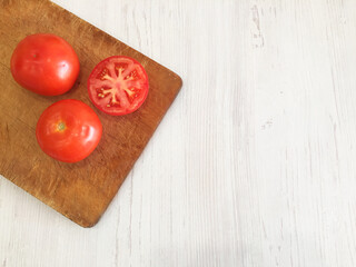 fresh vegetables, red tomato, juice on the table, tomato juice, orange juice, parsley, herbs, salad,  green tomatoes lie in a plate, tomatoes on a white background. 