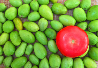 fresh vegetables, red tomato, juice on the table, tomato juice, orange juice, parsley, herbs, salad,  green tomatoes lie in a plate, tomatoes on a white background. 
