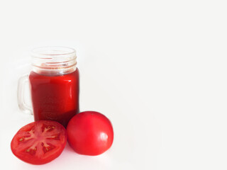 fresh vegetables, red tomato, juice on the table, tomato juice, orange juice, parsley, herbs, salad,  green tomatoes lie in a plate, tomatoes on a white background. 