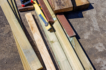 pile of timber beams on concrete to be used for landscaping work