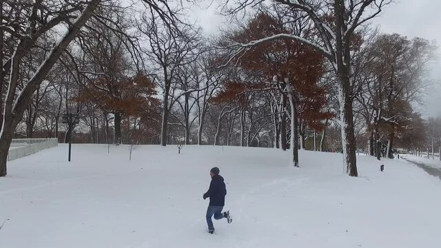 guy running in the snow in minnesota during winter time