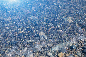 Sea pebbles under Black sea water. Transparent clean sea. View from the top.