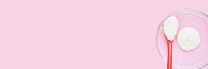 Collagen white powder. Pastel color background. Health product. Woman cosmetics concept. Sport supplement. Skincare cosmetics. Horizontal banner. Pink monochrome. Cream smear. Spoon