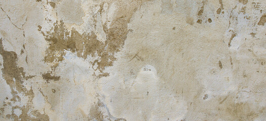 Grey concrete wall background texture. Old grunge uneven surface with scratches and cracks. Rough plaster cement gypsum wall outdoors