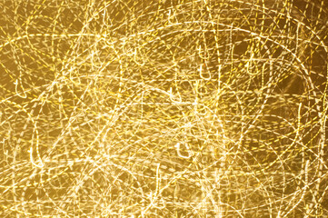 Long esposure speed of lights in golden color and various shape. Abstract festivebackground